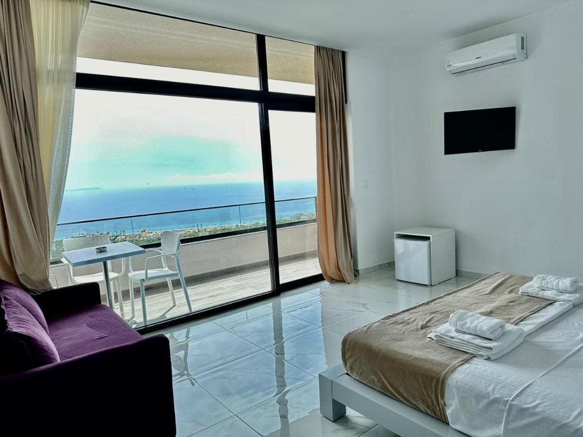 Sea-view balcony with chairs and table