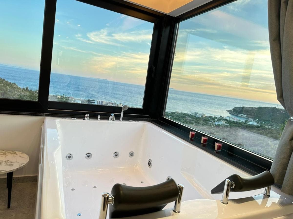 In-room spa bath facing a sunset sea view