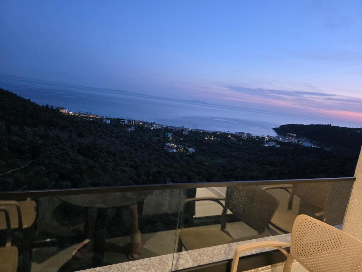 Dusk over the Himarë coastline from a Wait 'n Sea balcony