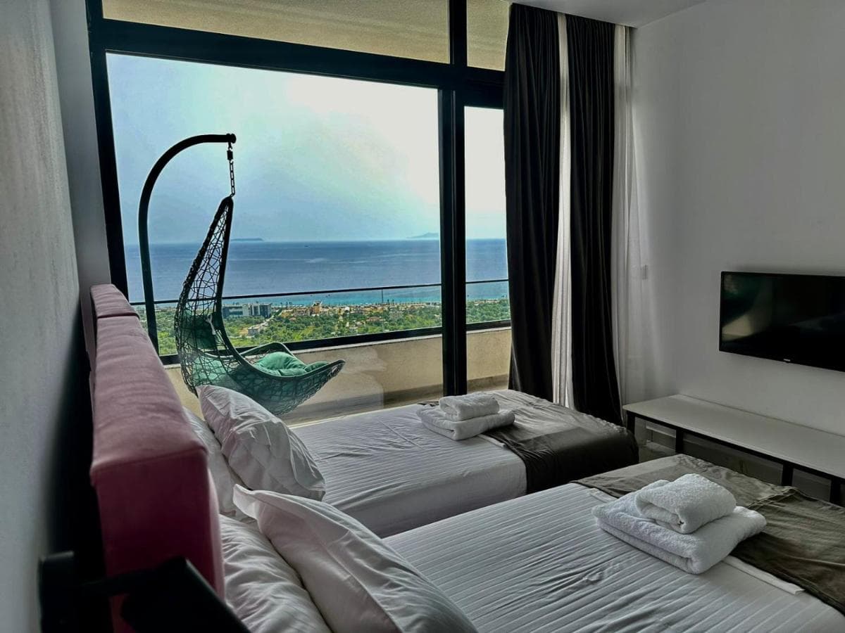 Double room with twin beds and a hanging balcony chair